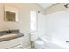 Bathroom with shower-tub combo, toilet, and vanity with gray countertop, complemented by a window at 4844 Creek Meadow Trl, Lakeland, FL 33810