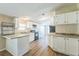 Bright kitchen with white cabinets, modern appliances, and a breakfast bar area at 4844 Creek Meadow Trl, Lakeland, FL 33810