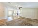 Open-concept living room with wood floors and carpet, seamlessly connects to the kitchen at 4844 Creek Meadow Trl, Lakeland, FL 33810