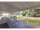 Spacious screened-in porch with wood flooring and outdoor view at 4844 Creek Meadow Trl, Lakeland, FL 33810