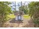 Small shed in backyard with grass and trees surrounding it at 4844 Creek Meadow Trl, Lakeland, FL 33810
