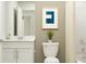 Bright bathroom with white vanity, modern fixtures, and a decorative art print at 947 Hour Glass Rd, Lakeland, FL 33801