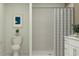 Modern bathroom with tiled shower, toilet, and stylish vanity, providing a relaxing space at 947 Hour Glass Rd, Lakeland, FL 33801