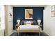 Stylish bedroom with dinosaur-themed art, a wooden bed frame, and blue accent wall at 947 Hour Glass Rd, Lakeland, FL 33801