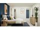 Modern bedroom with a blue accent wall, dresser, and a comfortable queen size bed at 947 Hour Glass Rd, Lakeland, FL 33801