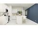 Modern kitchen with white cabinets, stainless steel appliances, and a sleek island at 947 Hour Glass Rd, Lakeland, FL 33801