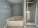 Bathroom with a soaking tub and glass shower at 1500 Fort Meade Pl, Poinciana, FL 34759