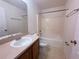 Bathroom with single sink vanity and shower-tub combo with a tiled floor at 1500 Fort Meade Pl, Poinciana, FL 34759