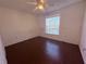 Bedroom with ceiling fan, window with blinds, and vinyl floors at 1500 Fort Meade Pl, Poinciana, FL 34759