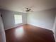 Bedroom with hardwood floors, neutral paint, and window at 1500 Fort Meade Pl, Poinciana, FL 34759
