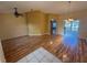 Spacious living room with wood-look flooring and bright natural light at 1500 Fort Meade Pl, Poinciana, FL 34759