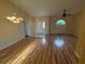 Open floor plan in living room with hardwood floors, natural light, and high ceilings at 1500 Fort Meade Pl, Poinciana, FL 34759
