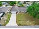 Aerial view of a well-maintained single-story home with a long driveway and mature landscaping at 206 Chris Ct, Davenport, FL 33896
