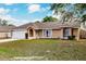 Charming single-story home featuring a two-car garage, manicured lawn, and lovely front entrance at 206 Chris Ct, Davenport, FL 33896