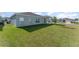 Spacious backyard featuring a grassy lawn and view of neighboring homes at 1336 Madison Cir, Haines City, FL 33844