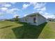 Large backyard featuring a grassy area and partial view of the home at 1336 Madison Cir, Haines City, FL 33844
