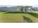 Spacious backyard featuring a grassy lawn and exterior view of the home at 1336 Madison Cir, Haines City, FL 33844