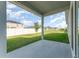 Covered patio with view of the large grassy backyard at 1336 Madison Cir, Haines City, FL 33844