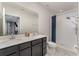 Bathroom featuring double sink vanity, white tile shower with modern fixtures, and a clean aesthetic at 1336 Madison Cir, Haines City, FL 33844