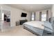 Comfortable bedroom featuring an ensuite bathroom, a large bed, and natural light from the windows at 1336 Madison Cir, Haines City, FL 33844