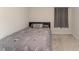 Neutral bedroom features a twin bed with window and neutral-toned linens at 1336 Madison Cir, Haines City, FL 33844