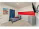 Bedroom featuring accent wall, dresser, and striped linens on bed at 1336 Madison Cir, Haines City, FL 33844