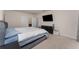 Bright bedroom with neutral walls, large bed, contemporary furniture, and a mounted television at 1336 Madison Cir, Haines City, FL 33844
