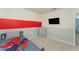 Bedroom featuring accent wall, dresser, mounted TV, and colorful linens on bed at 1336 Madison Cir, Haines City, FL 33844