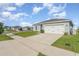A cozy one-story home featuring well-maintained lawns and a two-car garage at 1336 Madison Cir, Haines City, FL 33844