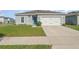 Charming single-story home with a well-manicured lawn and a two-car garage at 1336 Madison Cir, Haines City, FL 33844
