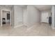 Neutral-toned hallway with tile flooring leading to a bedroom with hardwood floors at 1336 Madison Cir, Haines City, FL 33844