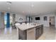 Open-concept kitchen with a granite island, stainless dishwasher, and tile floors flowing into the dining area at 1336 Madison Cir, Haines City, FL 33844