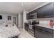 Modern kitchen featuring stainless steel appliances, granite countertops, and dark cabinetry at 1336 Madison Cir, Haines City, FL 33844