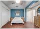 Bedroom with a blue accent wall, ceiling fan, and dark wood floors at 430 Alturas Babson Park Cutoff, Lake Wales, FL 33859