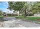 Sprawling single story home with mature trees and oversized driveway and grass lawn at 430 Alturas Babson Park Cutoff, Lake Wales, FL 33859