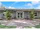 Inviting front entrance with double doors, gray walls, and small tropical plants, giving the home character at 430 Alturas Babson Park Cutoff, Lake Wales, FL 33859