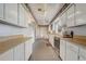 Well-lit kitchen featuring white cabinets, tile floors, and stainless steel appliances at 430 Alturas Babson Park Cutoff, Lake Wales, FL 33859