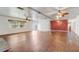 Open living room featuring hardwood floors, a brick fireplace, and expansive windows for natural light at 430 Alturas Babson Park Cutoff, Lake Wales, FL 33859
