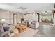 Living room with neutral-toned seating, a light rug, and adjacent dining area with table and chairs at 430 Alturas Babson Park Cutoff, Lake Wales, FL 33859