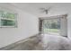 Bright living room features a ceiling fan, window view, and sliding glass door access to the yard at 430 Alturas Babson Park Cutoff, Lake Wales, FL 33859