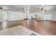 Open living room has light wood floors, fan, and brick fireplace with the words 'Mr & Mrs' on it at 430 Alturas Babson Park Cutoff, Lake Wales, FL 33859