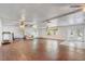 Open living room with light wood floors, fan, and brick fireplace with the words 'Mr & Mrs' on it at 430 Alturas Babson Park Cutoff, Lake Wales, FL 33859