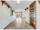 Spacious living room with hardwood floors, built-in shelves, and double doors leading to the outside at 430 Alturas Babson Park Cutoff, Lake Wales, FL 33859