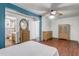 Main bedroom with wood floors, multiple furniture and a view into an adjacent bathroom at 430 Alturas Babson Park Cutoff, Lake Wales, FL 33859