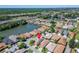 Aerial view showcasing homes close to a tranquil lake, featuring manicured lawns, mature trees, and convenient highway access at 622 Jamaica Cir, Lakeland, FL 33803