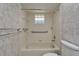 Neat bathroom showcasing a tiled tub with safety rails and glass block window at 622 Jamaica Cir, Lakeland, FL 33803