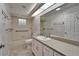 Well-lit bathroom featuring a vanity, large mirror, and a combined tub and shower at 622 Jamaica Cir, Lakeland, FL 33803