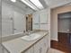 Bathroom featuring a long countertop, mirror, and wood-look floors in the adjoining room at 622 Jamaica Cir, Lakeland, FL 33803