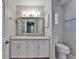 Bright bathroom featuring a white vanity with a large mirror and updated fixtures at 622 Jamaica Cir, Lakeland, FL 33803