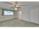 Spacious bedroom featuring plush green carpet, ceiling fan, and natural light at 622 Jamaica Cir, Lakeland, FL 33803